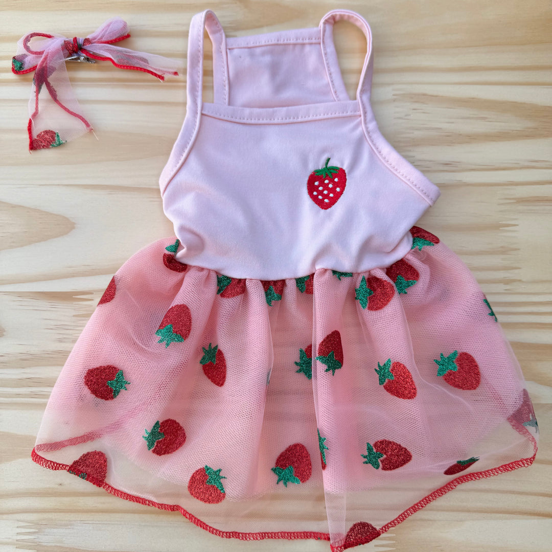 dog dress with strawberry pattern on a wooden surface